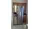 Kitchen area with a stainless steel refrigerator with water dispenser and oak cabinets at 12031 E Ford Cir, Aurora, CO 80012