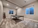 Spacious basement game room features a ping pong table and natural light at 9245 Star Streak Cir, Littleton, CO 80125