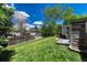 Expansive backyard featuring lush green lawn, mature trees, and a charming patio for outdoor enjoyment at 4539 E Caley Pl, Centennial, CO 80121