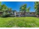 Large backyard with well-maintained lawn, enclosed patio, and mature trees providing shade and privacy at 4539 E Caley Pl, Centennial, CO 80121
