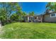 Spacious backyard with mature trees, green lawn, and a patio area for outdoor relaxation and entertainment at 4539 E Caley Pl, Centennial, CO 80121