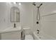 Clean bathroom with modern fixtures, including an arch mirror, sink and bathtub at 4539 E Caley Pl, Centennial, CO 80121