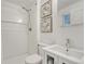 All-white bathroom includes a shower, toilet, sink, vanity, and decorative wall art at 4539 E Caley Pl, Centennial, CO 80121