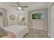Bright bedroom featuring a large window with curtains, carpet, and a ceiling fan at 4539 E Caley Pl, Centennial, CO 80121