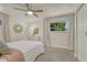 Cozy bedroom with a large window, neutral decor, carpet, and a ceiling fan at 4539 E Caley Pl, Centennial, CO 80121
