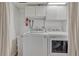 This laundry room has a side-by-side washer and dryer set, and overhead storage at 4539 E Caley Pl, Centennial, CO 80121