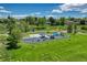 Aerial view of a modern, colorful playground with slides, swings, and climbing structures in a green park at 4539 E Caley Pl, Centennial, CO 80121