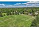Aerial view of a well-maintained soccer field with green grass and a backdrop of trees and city buildings at 4539 E Caley Pl, Centennial, CO 80121