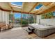 Relaxing sunroom with vaulted wood plank ceiling, hot tub, and serene backyard views at 4539 E Caley Pl, Centennial, CO 80121