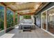 Enclosed sunroom showcasing a hot tub, wood plank ceiling, and picturesque outdoor views at 4539 E Caley Pl, Centennial, CO 80121