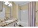 Bathroom featuring granite vanity, shower and tub combination, and neutral walls at 1308 S Danube Way # 102, Aurora, CO 80017
