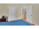 Bedroom with neutral walls and open doorway leading to the home's upper level at 1308 S Danube Way # 102, Aurora, CO 80017
