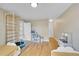 Spacious bedroom featuring hardwood floors, two twin beds, climbing frame, and access to additional rooms at 1308 S Danube Way # 102, Aurora, CO 80017