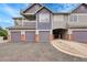 Multi-Gathering exterior with garage doors and brick accents in a residential neighborhood at 1308 S Danube Way # 102, Aurora, CO 80017