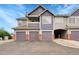 Multi-Gathering exterior with garage doors and brick accents in a residential neighborhood at 1308 S Danube Way # 102, Aurora, CO 80017