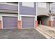 Multiple garages with brick accents offer private parking in front of the townhome, highlighting its design and convenience at 1308 S Danube Way # 102, Aurora, CO 80017