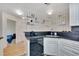 Modern kitchen featuring decorative shelving, stainless steel sink, sleek appliances, and ample countertop space at 1308 S Danube Way # 102, Aurora, CO 80017