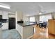 Open kitchen and dining area with modern appliances and hardwood floors in a well-lit, comfortable home at 1308 S Danube Way # 102, Aurora, CO 80017