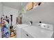 Functional laundry room with washer, dryer, shelving, and efficient water heater at 1308 S Danube Way # 102, Aurora, CO 80017