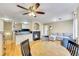 Spacious living room with hardwood floors and a fireplace connects seamlessly to the kitchen, creating an open and airy atmosphere at 1308 S Danube Way # 102, Aurora, CO 80017