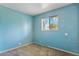This cozy bedroom features a large window providing natural light and neutral carpet flooring at 1060 Saulsbury St, Lakewood, CO 80214