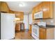 A kitchen featuring wooden cabinets, white appliances and granite-like countertops at 1060 Saulsbury St, Lakewood, CO 80214