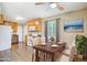 Open eat-in kitchen with wooden cabinets, white appliances and dining room table at 1060 Saulsbury St, Lakewood, CO 80214