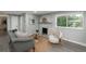 Living room with a modern stone fireplace and neutral decor at 3449 W Alamo Pl, Littleton, CO 80123