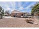 Backyard showing brick exterior, garden area with planters, a patio and a fenced area at 1008 Yeager Dr, Longmont, CO 80501