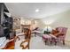 Carpeted basement area with fireplace and adjacent shelving with various decorative items at 1008 Yeager Dr, Longmont, CO 80501