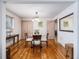 Bright dining room featuring hardwood floors and a decorative lighting fixture over a glass table at 1008 Yeager Dr, Longmont, CO 80501