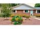 Beautiful front yard with meticulous landscaping and brick home with well-maintained details at 1008 Yeager Dr, Longmont, CO 80501