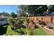 View of a backyard garden featuring a wooden trellis, an abundance of vegetables, and decorative flower pots at 1008 Yeager Dr, Longmont, CO 80501