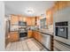 Updated kitchen featuring stainless steel appliances, granite countertops, and tile flooring at 1008 Yeager Dr, Longmont, CO 80501