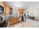 Well-lit kitchen with stainless steel appliances, tile backsplash, and ample wood cabinetry at 1008 Yeager Dr, Longmont, CO 80501