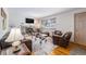 Inviting living room boasts a stone fireplace, hardwood floors, and comfortable leather furniture at 1008 Yeager Dr, Longmont, CO 80501