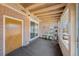 Enclosed patio features brick walls, sliding glass door, carpet, and a view of the exterior of the property at 1008 Yeager Dr, Longmont, CO 80501