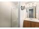 Bathroom featuring a vanity with a sink, a mirror, and a glass-enclosed shower stall at 3953 S Richfield St, Aurora, CO 80013
