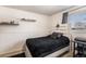 Simple bedroom featuring a bed, a window, and minimalist decor at 3953 S Richfield St, Aurora, CO 80013