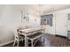 Dining room with a farmhouse-style table, bench seating, and modern decor at 3953 S Richfield St, Aurora, CO 80013
