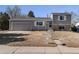 Two-story home with gray siding, brick accents, and a well-maintained front yard and an attached garage at 3953 S Richfield St, Aurora, CO 80013