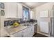 Well-lit kitchen with granite countertops, stainless steel appliances, and modern fixtures at 3953 S Richfield St, Aurora, CO 80013