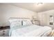 A beautifully staged bedroom with a queen bed, matching nightstands and a dresser with light paint colors at 3953 S Richfield St, Aurora, CO 80013