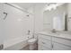 Well-lit bathroom featuring a shower-tub combo and a vanity with a neutral countertop at 1257 Rhett Dr, Erie, CO 80026