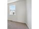 Sunlit bedroom boasting neutral walls, plush carpet, and a bright window view at 1257 Rhett Dr, Erie, CO 80026