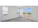 Bright bedroom with three windows offering a scenic view of the neighborhood at 1257 Rhett Dr, Erie, CO 80026