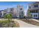 Modern townhome shows attractive multi-story design, sidewalk, and lawn space at 1257 Rhett Dr, Erie, CO 80026