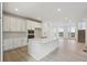 Open kitchen features white cabinets, stainless steel appliances, and center island at 1257 Rhett Dr, Erie, CO 80026