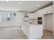 Bright kitchen offers white island, modern appliances, and plentiful counter space at 1257 Rhett Dr, Erie, CO 80026