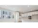 Bright kitchen showcases white cabinets, stainless steel appliances, and large windows at 1257 Rhett Dr, Erie, CO 80026